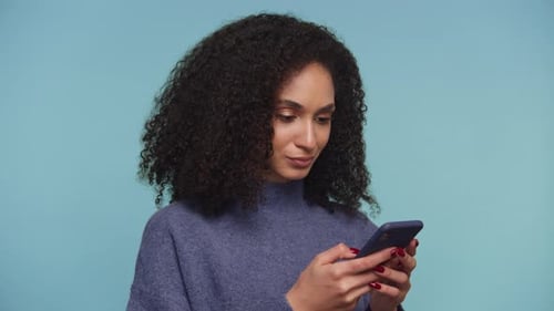 Young Woman Shocked by Message on Cellphone