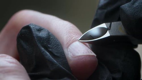 Cutting Cuticle with Nail Clippers in Macro Shot