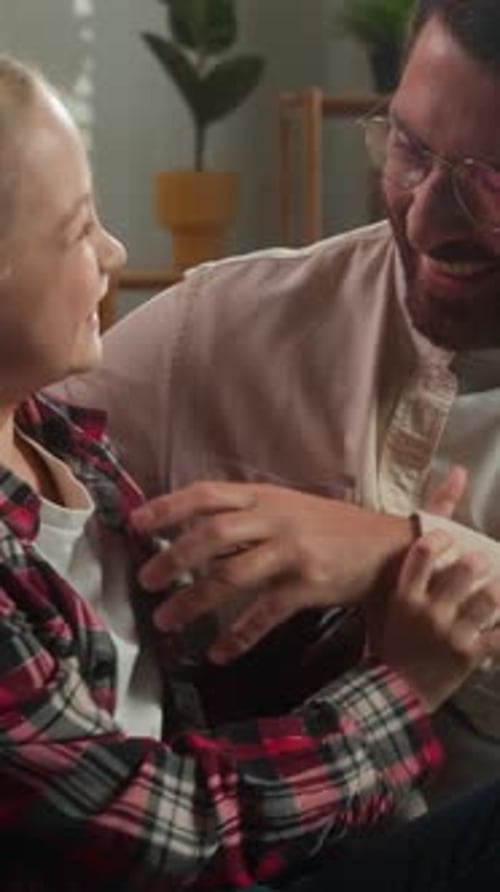 Smiling Girl Embraces Father in Living Room