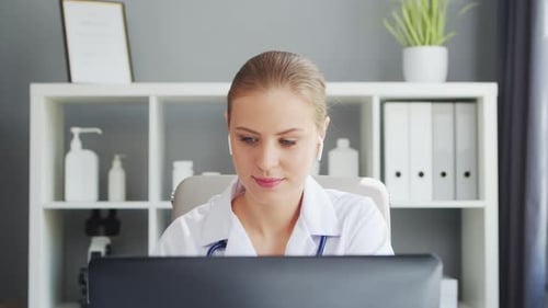 Doctor Works in the Medical Office Woman in White Coat Workplace of a Professional Female Therapist