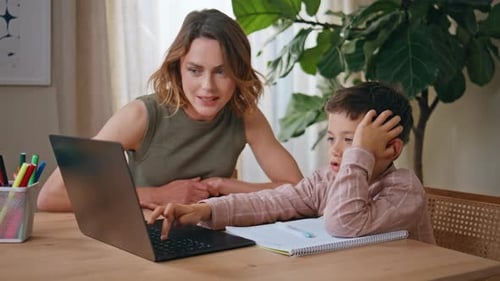 Woman and Child Using Laptop at Home