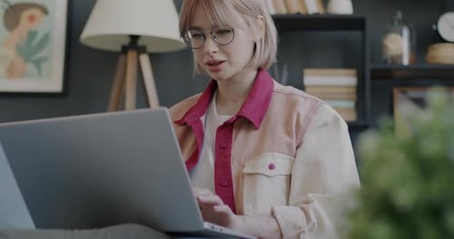 Woman Works on Laptop From Home on Couch