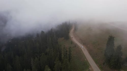 Cars On The Foggy Road In The Mountains
