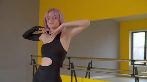 Elegant Inspired Female Dancer Gracefully Dancing During Rehearsal in Studio