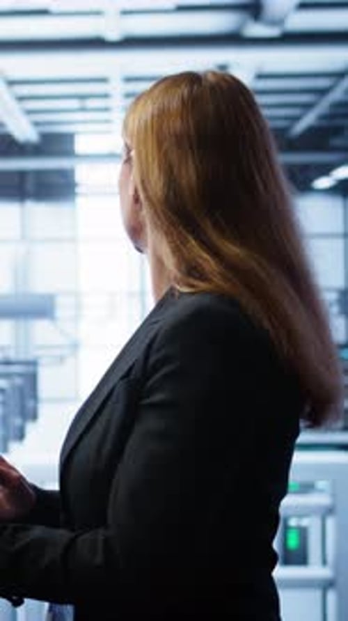 Vertical Video Woman Working in Data Center Housing Advanced Data Storage Infrastructure