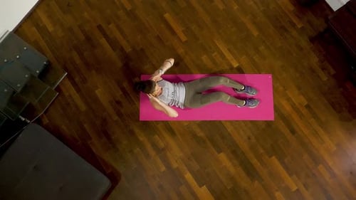 Woman Doing Crunches on Yoga Mat, Birds Eye View