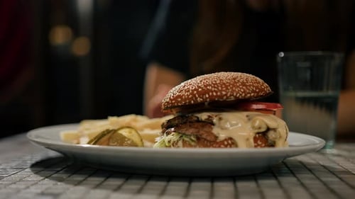 Close-up - beautiful tasty burger with french fries on the table in the restaurant