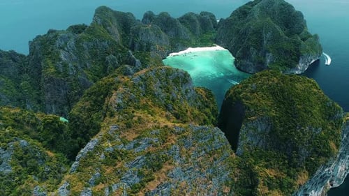 Aerial view of iconic tropical turquoise water Pileh Lagoon surrounded by limestone cliffs, Phi Phi