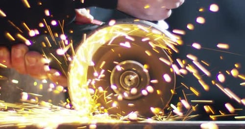 .blacksmith or welder,with its grinding smooths steel and iron,in extreme slow motion,to make the