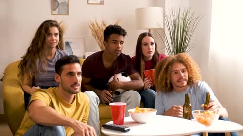 Friends Cheer while Watching Sports Game at Home