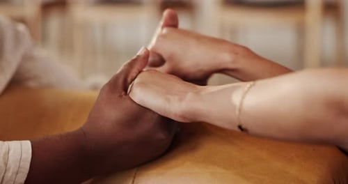 Holding hands, love and couple in home for support, comfort or bonding together in living room