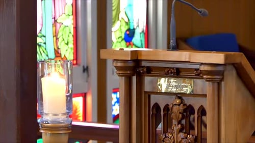 Shot of lighted candles used for prayers in memorial wedding funeral services in a religious church