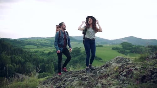 Couple Hiking Together in Green Mountain Landscape