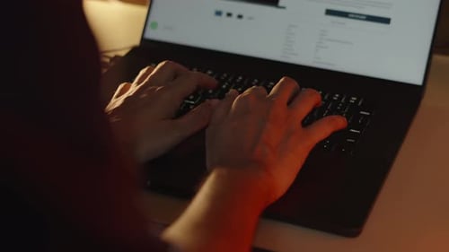 Person Typing On Laptop Computer Close Up