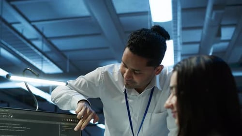 Colleagues Collaborating on Software in Technology Workspace