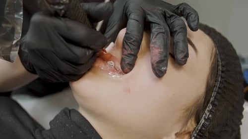 Permanent makeup application process for a girl at a cosmetology studio in a busy urban area