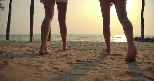 Slow motion: Close up Women friends running enjoy life playing and freedom beach at sunset