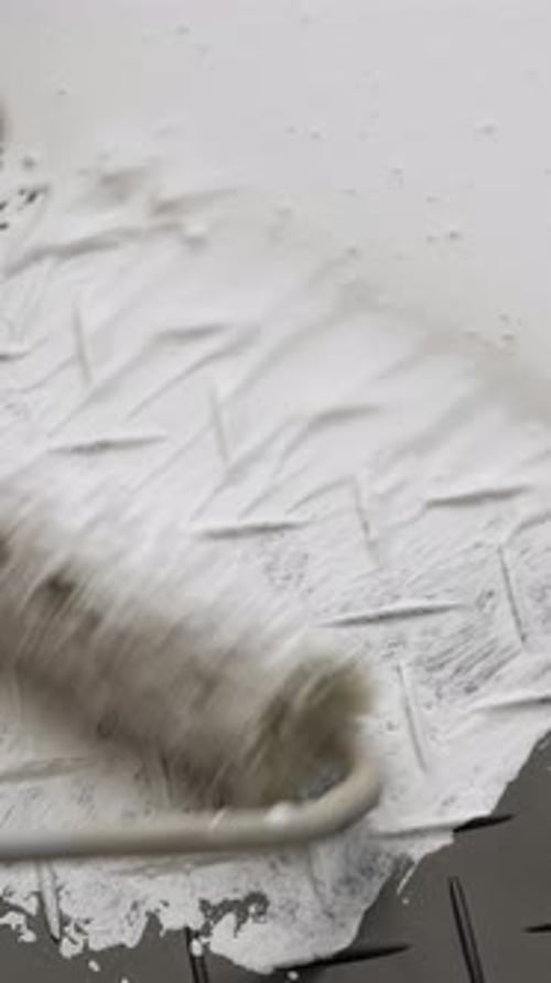 Painting Wall with White Color Paint Closeup Vertical