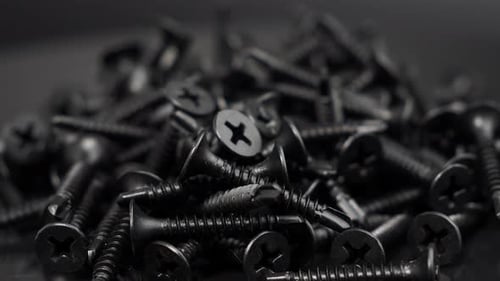 Pile of Black Screws Close Up