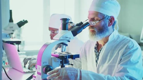 Senior Scientist Using Microscope in Modern Laboratory