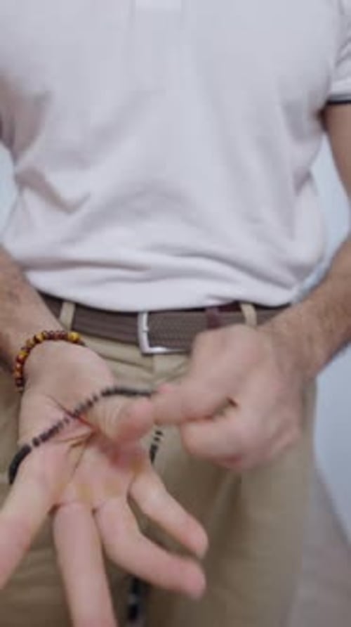 Man with Curly Hair Puts on Sunglasses
