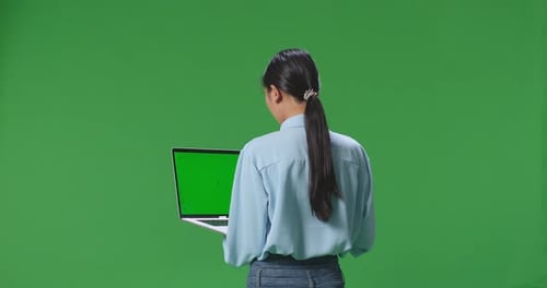 Asian Business Woman Using Laptop Computer With Mock Up Green Screen On Green Screen Background