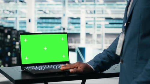 Green Screen Mockup Laptop Network Management and Engineer in Server Farm