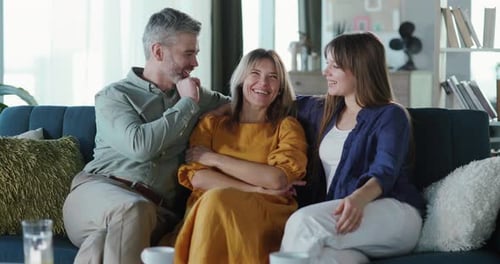 Happy Family Bonding on Couch Together