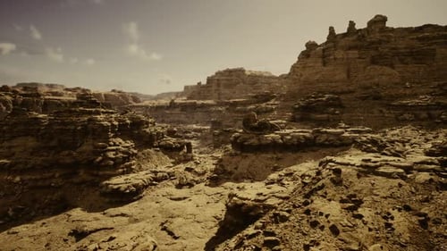 Sunlit Rocky Gorge Featuring Stratified Cliffs and Rugged Terrain