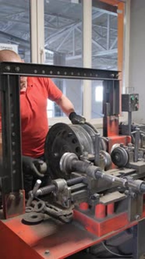 Portrait of a Mechanic Repairing Car Wheels Car Service Vertical Video