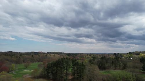 Aerial view of green golf course and trees, United States.