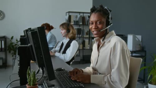 Portrait of Cheerful Young Woman with Headset Working as Call Centre Operator