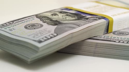 Stack of Bank Bundles with US Dollars on a White Background Closeup Shot of New Freshly Printed