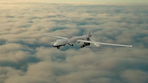 Military Drone Flying Above Clouds
