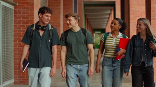 Diverse Group of University Students Walking and Talking in a Hallway