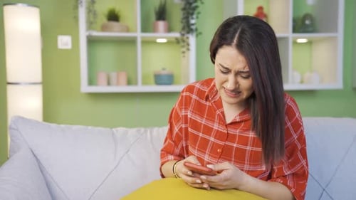 Woman Reacting to Content on her Mobile Phone