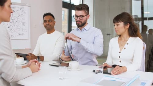 Business Meeting with Diverse Team in Bright Office