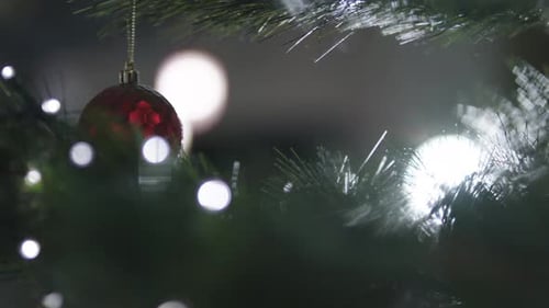 Christmmas Ornaments and Tinesel on a christmas tree extreme close up