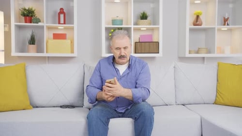 Alter Mann, der schlechte Nachrichten am Telefon bekommt. Unglücklich.