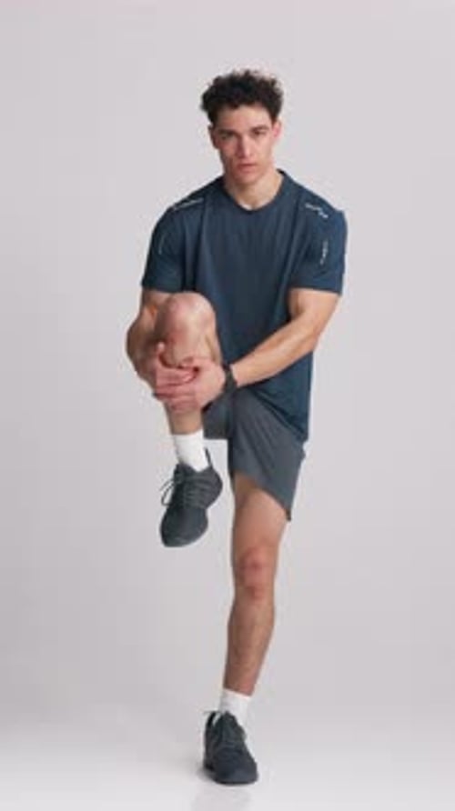 Fitness, face or man in studio with hamstring pull, muscle preparation or exercise in body activity