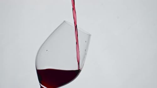 Red Wine Being Poured into Glass