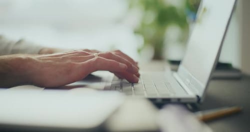 Closeup of Businessman's Hand Using Laptop at Office