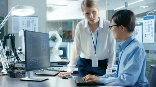 Female Engineers Collaborate in High Tech Office