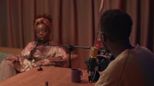 Podcast Host Communicating with Female Musician in Studio