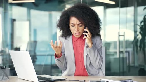 Angry Woman Arguing on Mobile Phone in Office
