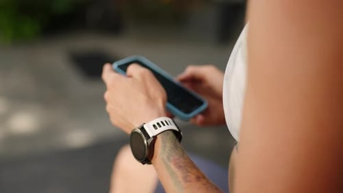 Redhead Female Athlete Syncs Smart Watch with Smartphone in Luxury Tropical Gym Pro Tracks Workout