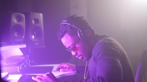 Professional Black Sound Engineer Working in Modern Audio Recording Studio