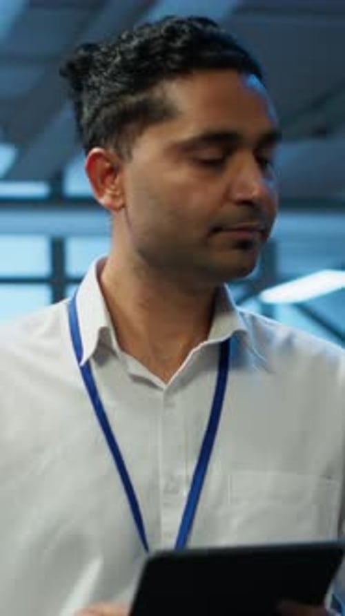 Vertical Video Programmer Walking in High Tech Data Center Used for Managing Gear Energy