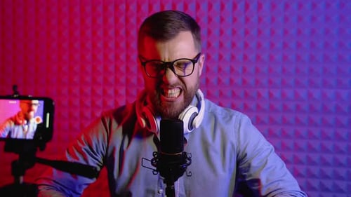 Vlogger Using Microphone and Headphones to Record Vlog for Channel