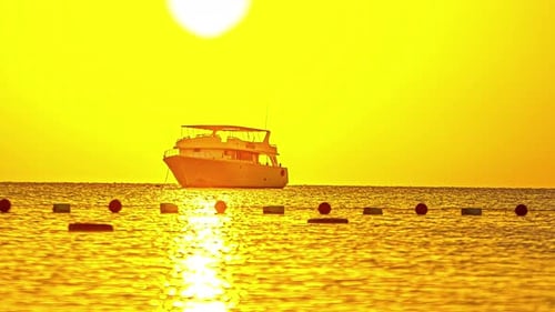 Reflection of bright sunlight above a yacht moored at an anchor. Timelapse